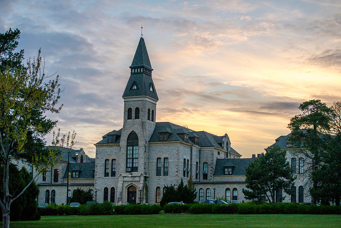 The sun sets behind Anderson Hall on April 14, 2015.